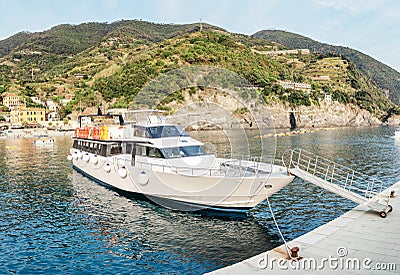 cruise boat with tourists sailing in Cinque Terre national park in the Mediterranean or Ligurian Sea Stock Photo