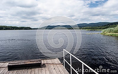Ferry on Lipno water reservoir with Sumava mountains on the background Stock Photo