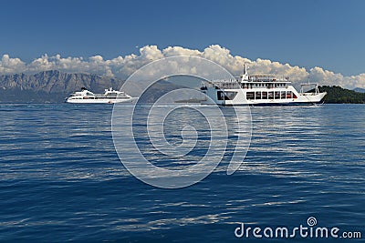 Ferryboat and cruiser ship in calm blue sea Stock Photo