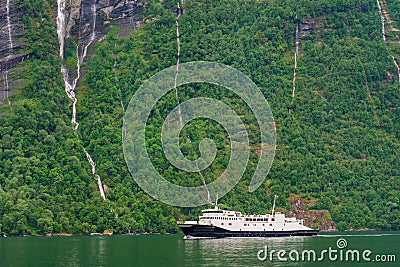 Ferryboat on the Geirangerfjord with mountains in Norway Editorial Stock Photo
