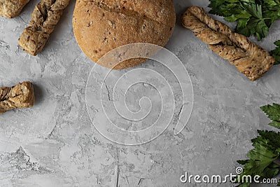 Fersh bread and green parsley on the grey backgrounnd Stock Photo