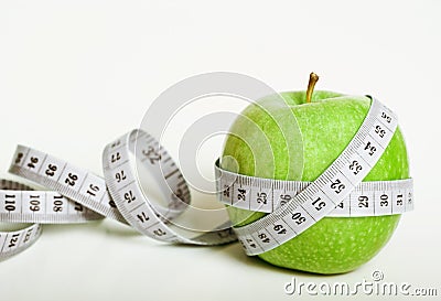 Fersh green apple with measuring tape Stock Photo
