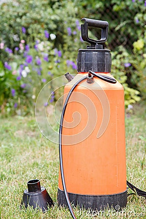 Fertilizer pesticide garden sprayer on green grass Stock Photo