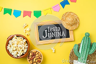 Festa Junina party background with popcorn, peanuts and chalkboard. Brazilian summer harvest festival concept. Top view, flat lay Stock Photo