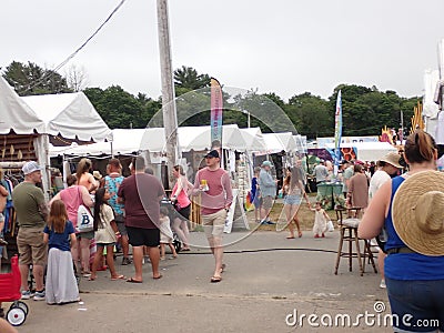 festival partakers meandering about.. vendors for food, shopping, tarot, Editorial Stock Photo