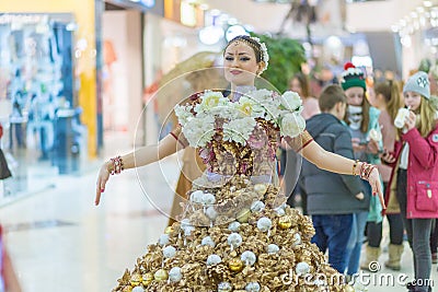 the festival of plasticine rain. A girl in a beautiful dress decorated with flowers and Christmas balls Editorial Stock Photo