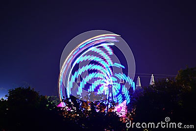 Festival Rides and Tree Silhouettes Stock Photo