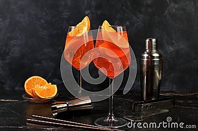 Festive alcoholic cocktail Aperol spritz in glasses on a dark background, concept for bar and New Year's Eve, alcoholic Stock Photo