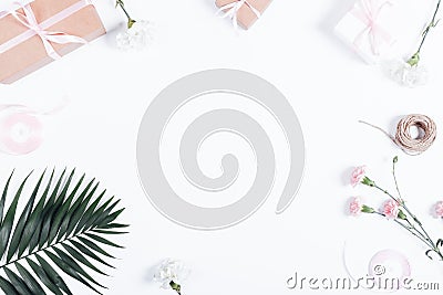 Festive arrangement: boxes with gifts, ribbons and flowers on white table Stock Photo