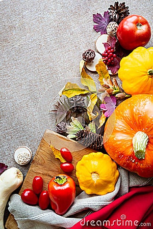 Festive autumn composition from pumpkins, leaves, tomato and squash on the beige background. Stock Photo