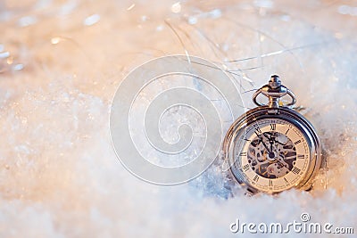 New year, almost midnight. Festive background, antique clock in the snow Stock Photo