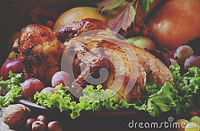 Festive baked chicken with autumn berries, fruits, nuts and vegetables in the rustic style of the old wooden Stock Photo