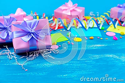 Festive bright blue background decoration for holiday colored confetti serpentine paper gifts Top view flat lay copy space Stock Photo