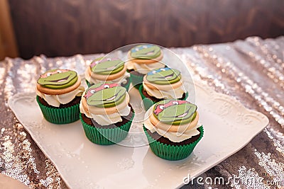 Festive candy bar for boy birthday party. Blue cupcakes with Teenage Mutant Ninja Turtles. Sweets for family event Editorial Stock Photo