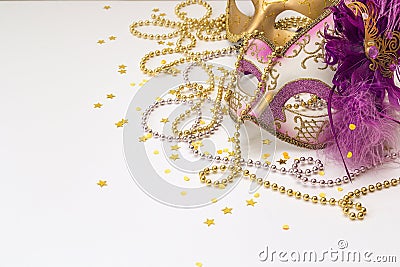 Festive Carnival Background with masks, beads and copy space. Stock Photo