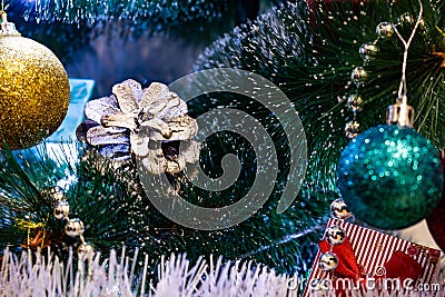 Festive Christmas composition, decorations on the Christmas tree, gift boxes, packaging and tinsel and silver beads. Toys and deco Stock Photo