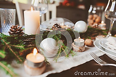 Festive Christmas and New Year table setting in scandinavian style with rustic handmade details in natural and white tones Stock Photo