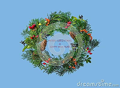 Festive Christmas wreath with rosehip, sea buckthorn, winter berry holly, mistletoe, fir and pine cones Stock Photo