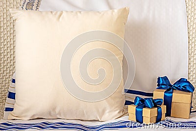 Composition with blank grey pillow and gift boxes on tallit Stock Photo