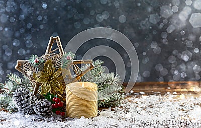 Festive composition with a Christmas star and a burning candle Stock Photo