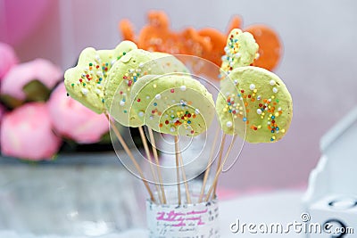 Festive cookie pops or cookies on sticks. Birthday candy bar with spring flowers for girl Editorial Stock Photo