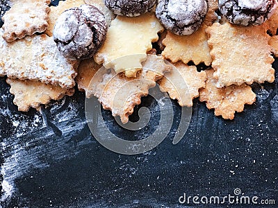 Festive cookies on a black kitchen board with powdered sugar Stock Photo