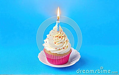 Festive cupcake with a candle on a blue background. With space for text Stock Photo
