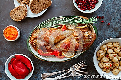 Festive dish for Thanksgiving, roasted turkey legs with vegetables on a table with snacks. Stock Photo