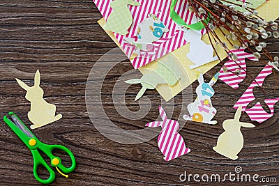 Festive Easter decor with handmade decoration of colorful rabbits on a wooden background. Stock Photo