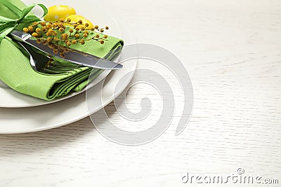 Festive Easter table setting with mimosa flowers. Space for text Stock Photo