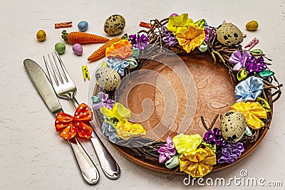 Hand crafted Easter wicker wreath with quail eggs and handmade flowers. Birch branches, polka dot satin ribbon. Stay at home Stock Photo