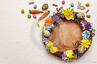 Hand crafted Easter wicker wreath with quail eggs and handmade flowers. Birch branches, polka dot satin ribbon. Stay at home Stock Photo