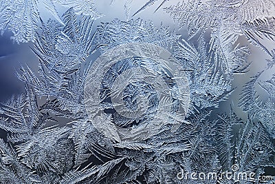 Festive frosty pattern with white snowflakes on a blue background on glass Stock Photo