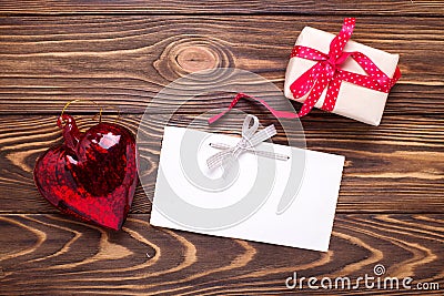 Festive gift box with present and empty tag on aged wooden bac Stock Photo