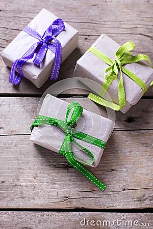 Festive gift boxes with presents on vintage wooden background. Stock Photo