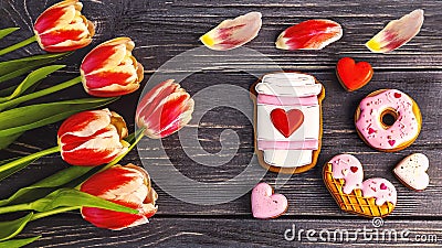 Festive gift gingerbread for Valentine's Day in the form of a cup of coffee, hearts, a donut, a bouquet of tulips Stock Photo