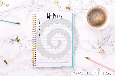 Festive golden stationary and coffee on white marble background. My Plans wording. Copy space Stock Photo