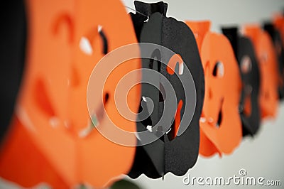 Festive Halloween pumpkins paper garland. Holidays, decorations and party concept. Stock Photo
