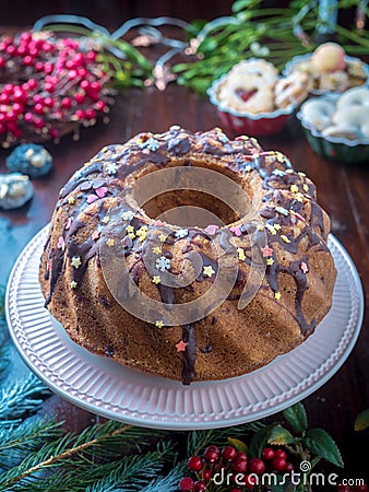 Festive homemade round biscuit cake with hole on porcelain shelf Stock Photo