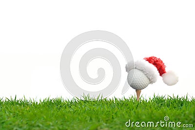 Festive-looking golf ball on tee with Santa Claus` hat Stock Photo