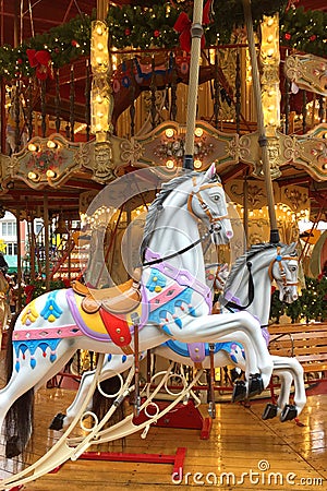 Festive merry-go-round carousel with horses and lights in Frankfurt during the Christmas market, Christmas holiday Stock Photo