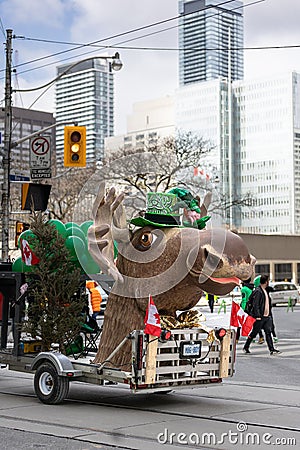 A festive moose float dressed up in green at the St Patrick's Day parade Editorial Stock Photo