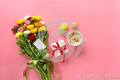 Festive morning concept buttercup flowers bouquet, gift box, cup of cappuccino and makarons cake on the pink background with copy Stock Photo