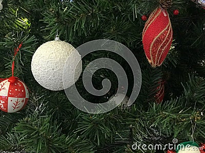 Festive multicolored beautiful shiny fancy balls, toys, gift boxes, decorations on the Christmas green tree with needles Stock Photo