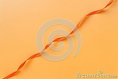 Festive orange ribbon waves on orange background Stock Photo