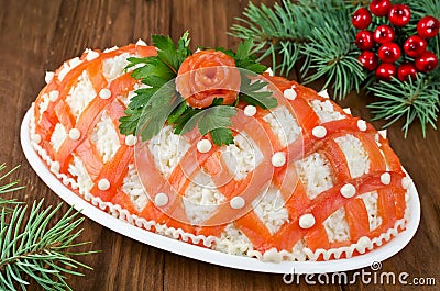 Festive salad, decorated with salmon on a wooden table Stock Photo