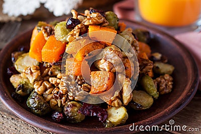 Festive salad with brussels sprout, pumpkin, nuts, cranberries Stock Photo