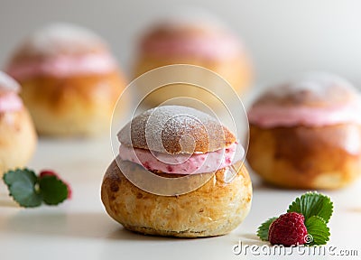 Festive Semlor or Semla : Traditional Scandinavian Buns flavored with cardamom filled with almond paste & raspberry whipped cream Stock Photo