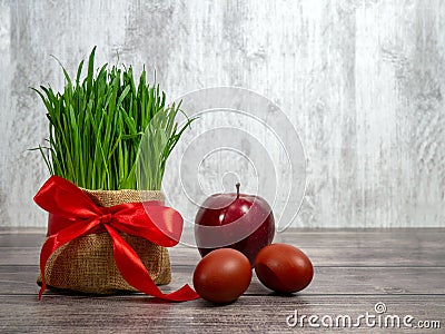 Festive table in honor of Navruz. Wheat with a red ribbon, the traditional holiday of the vernal equinox Nawruz Stock Photo