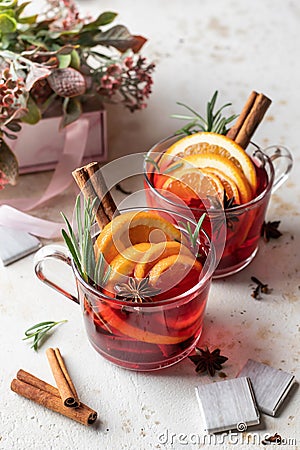 Festive valentines composition with mulled wine, spices, flowers, sweets and gift on white textured background Stock Photo